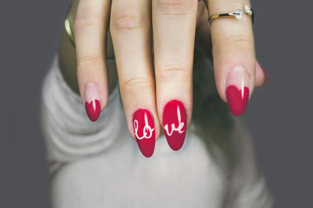 girl showing her fashion nail-art in dark pink color